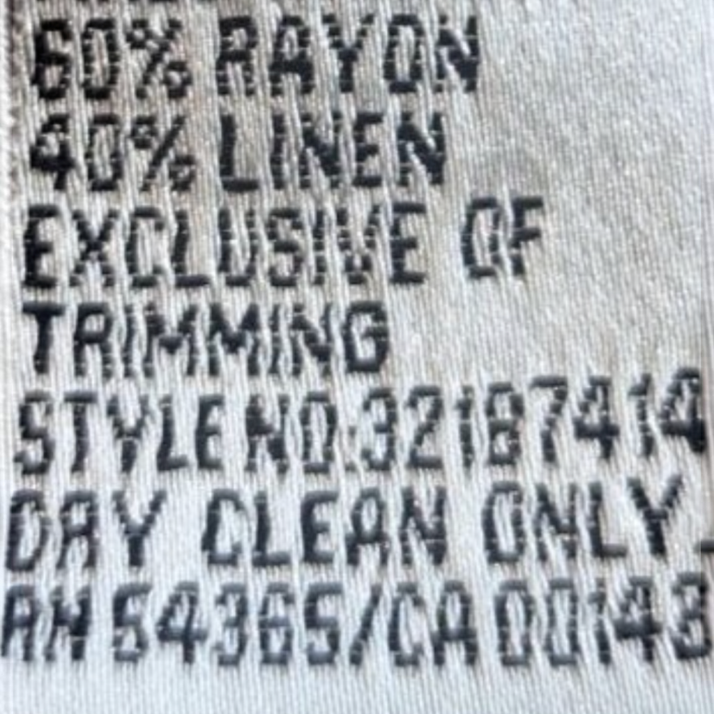 Recycle Me Fancy NYGÅRD vintage jacket fabric care label showing 60 percent rayon and 40 percent linen composition