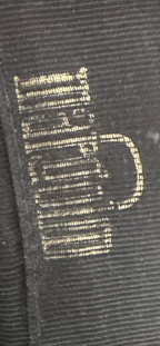 Recycle Me Fancy vintage clutch interior featuring a metallic gold logo printed on black fabric lining