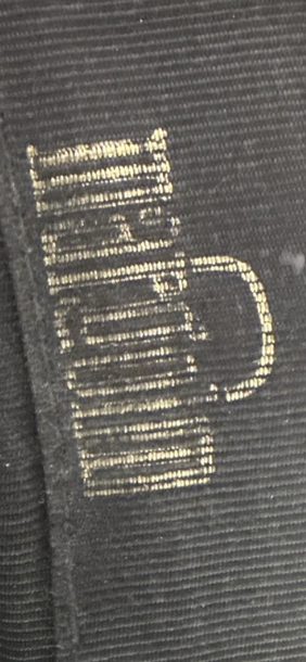 Recycle Me Fancy vintage clutch interior featuring a metallic gold logo printed on black fabric lining