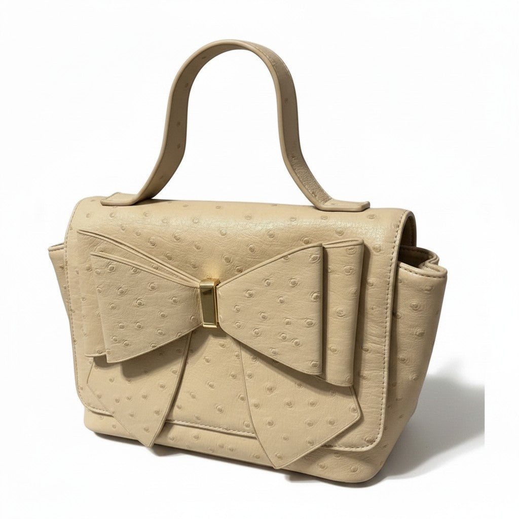 Recycle Me Fancy vintage cream ostrich-embossed leather handbag with an oversized bow and gold-tone hardware.