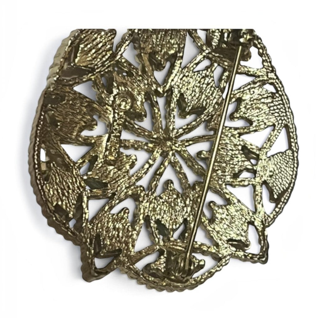 Back view of a Recycle Me Fancy vintage gold-tone filigree brooch showing the secure pin-back closure mechanism.