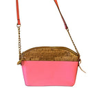 Recycle Me Fancy pink pebbled leather and natural cork crossbody bag with a gold chain strap and lion emblem accent.