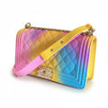 Recycle Me Fancy rainbow ombre quilted jelly crossbody bag with gold-tone chain strap and twist-lock closure.