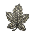 Recycle Me Fancy vintage silver-tone maple leaf brooch with clear pavé-set rhinestones on a metal base.