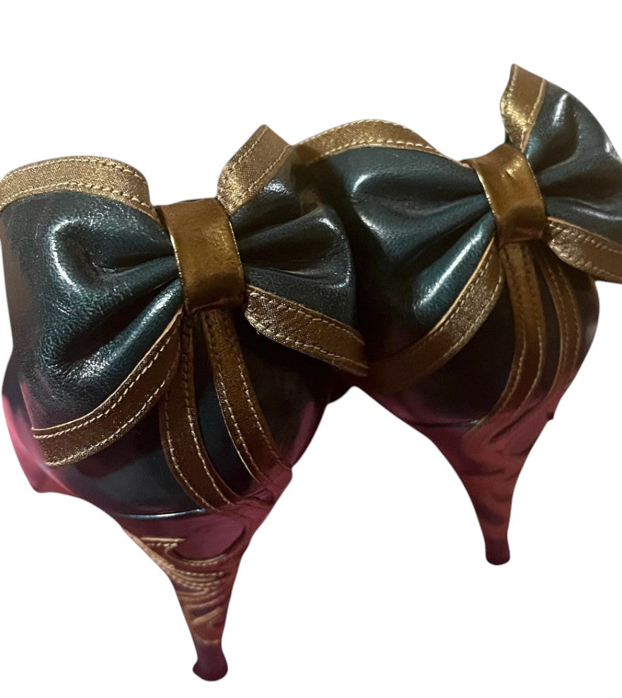 Recycle Me Fancy vintage teal green patent pumps featuring an oversized bronze bow and swirl stitching on the heel.