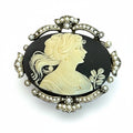Recycle Me Fancy vintage cameo brooch featuring a cream profile on black with a silver-tone seed pearl bow frame.