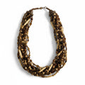 Recycle Me Fancy vintage multi-strand necklace featuring carved bone, amber glass, and black beads in a boho style.